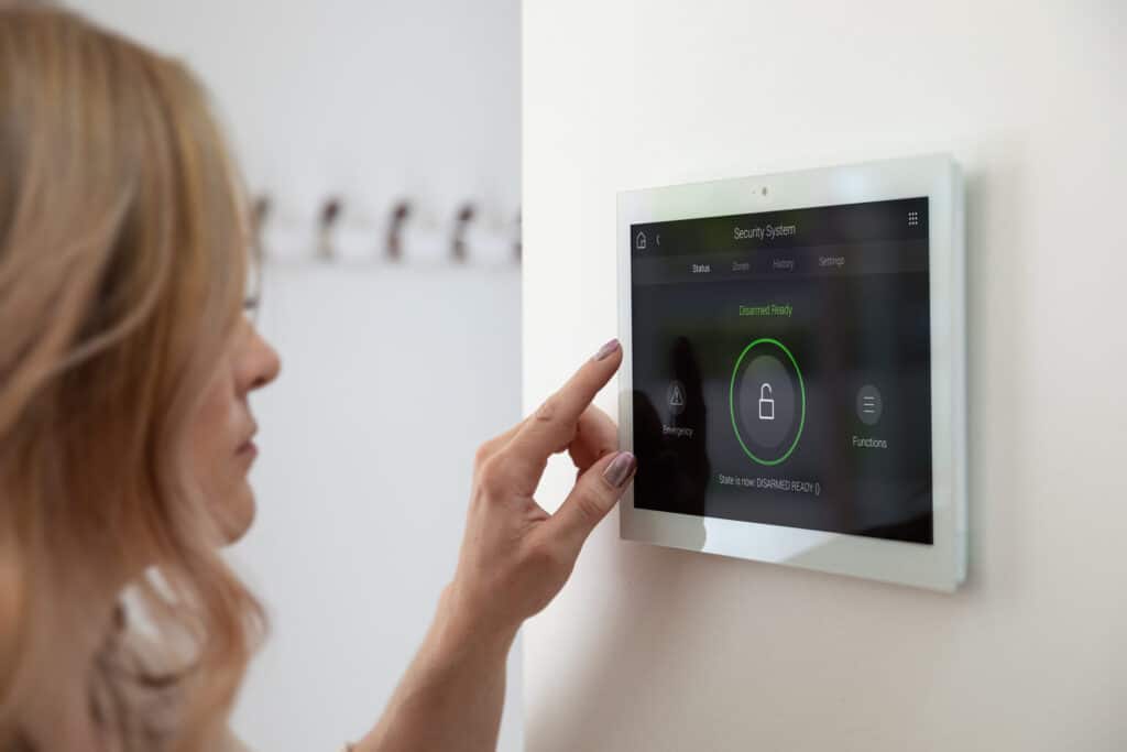Lady hovering a finger over her smart home controls